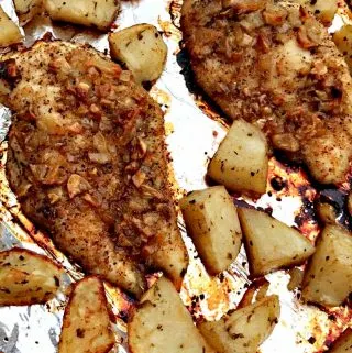 garlic brown sugar chicken and roasted potatoes on a foil lined baking sheet