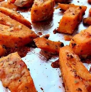 Parmesan Sweet Potatoes on a foil lined baking sheet