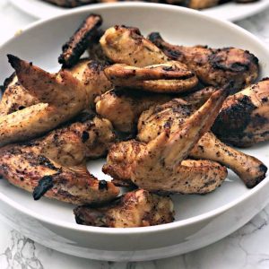 grilled bbq chicken wings in a large white bowl