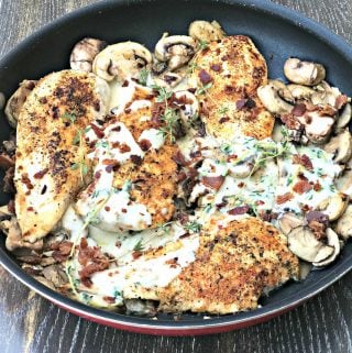 bacon mushroom chicken in cream sauce with thyme in a skillet