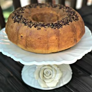 rum bundt cake on a white cake stand