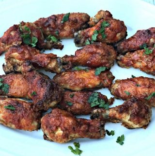 air fryer sriracha honey bourbon fried chicken wings on a white platter