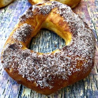 Air Fryer Cinnamon Sugar Donuts on a multi colored surfaced