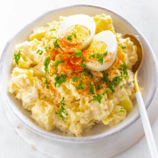 instant pot potato salad with boiled eggs in a pink bowl