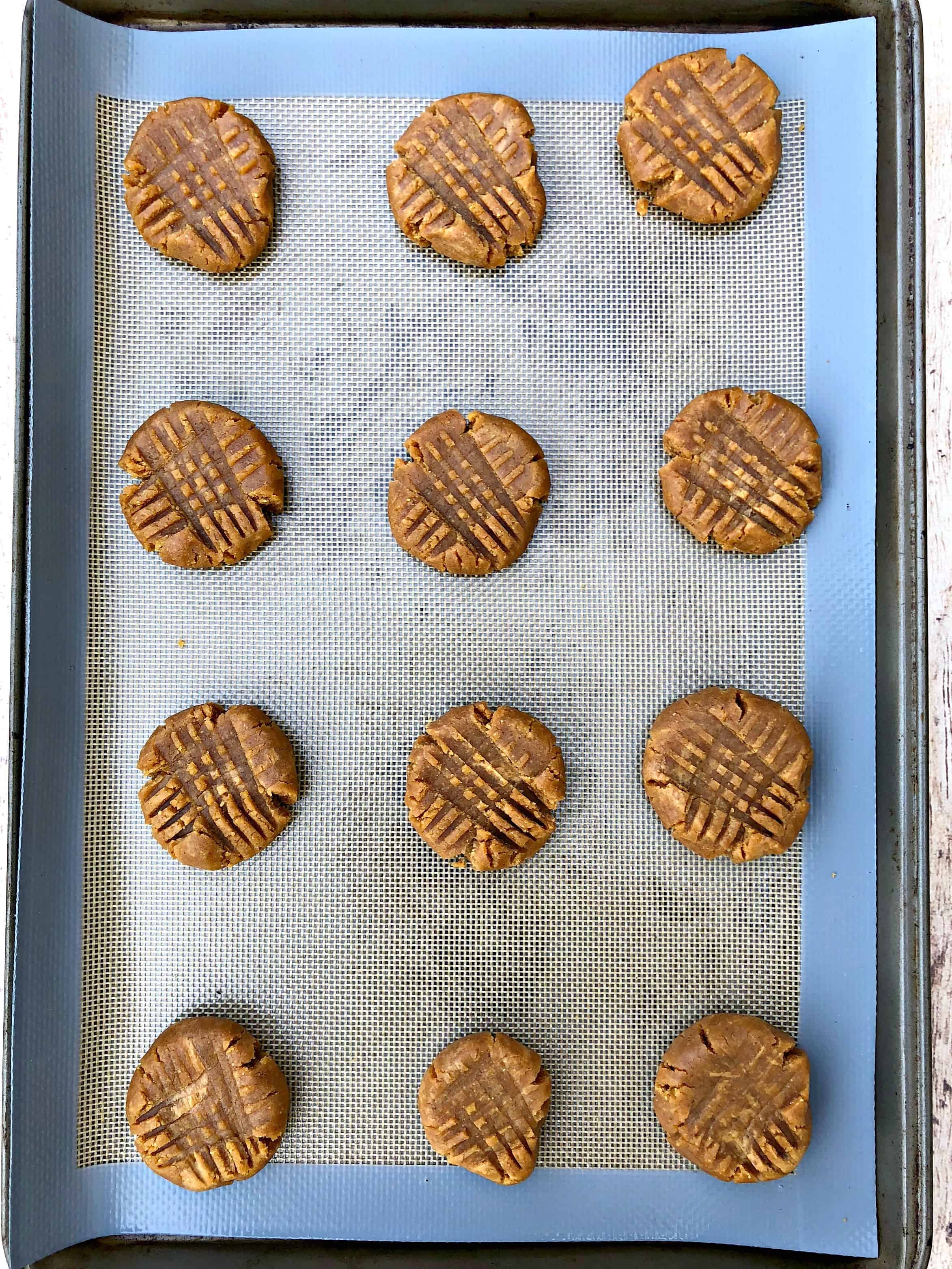 raw cookie dough balls on a cookie sheet