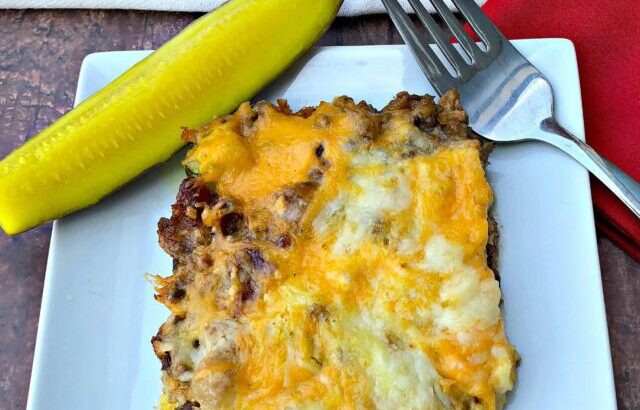 keto cheeseburger casserole with pickle on a white plate