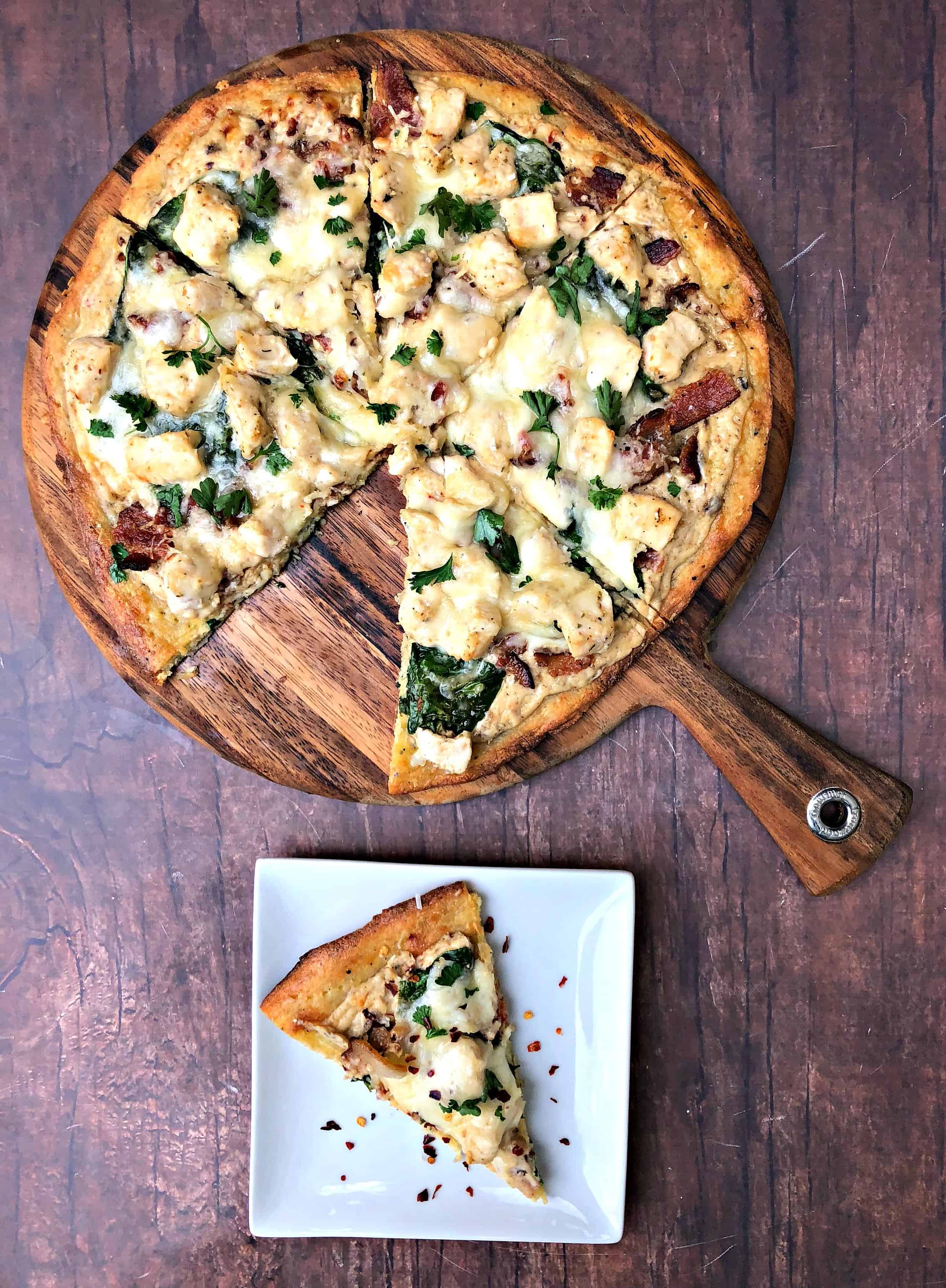 keto fathead alfredo bacon chicken pizza sliced and on a plate