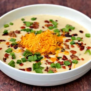 instant pot potato soup with bacon and cheese in a white bowl