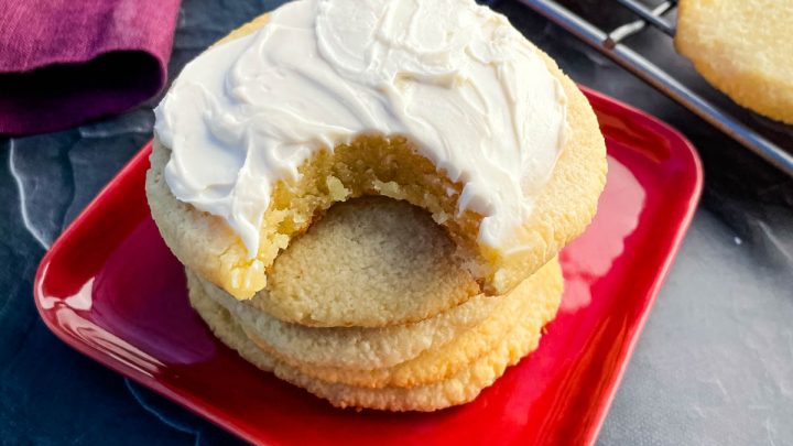 keto low carb sugar cookies on a plate with cream cheese icing