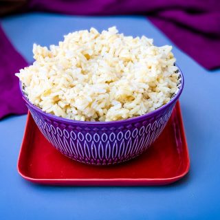 Instant Pot brown rice in a purple bowl