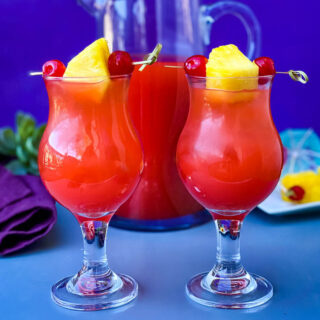 Bahama Mama Recipe in glasses with a pitcher of drink