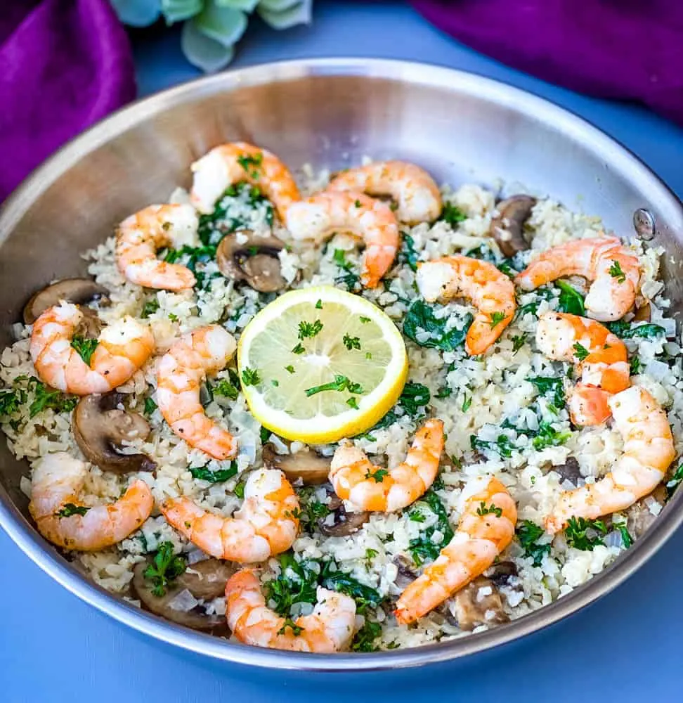 keto low carb cauliflower risotto in a pan with lemon and shrimp