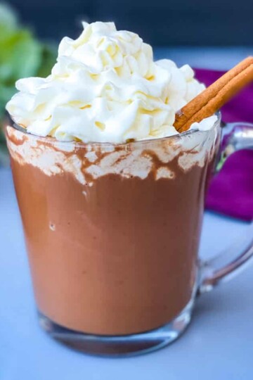 keto low carb hot chocolate in a glass mug with whipped cream and cinnamon