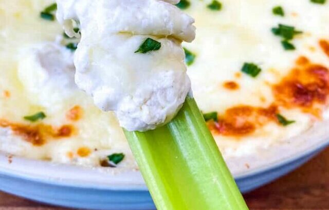 celery with crab rangoon dip in a blue baking dish