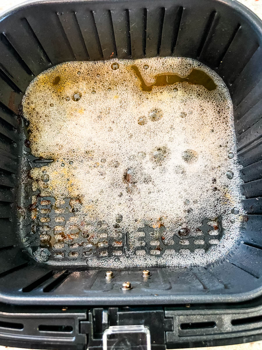 air fryer basket with water and dish liquid