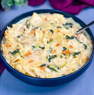 chicken lasagna soup in a blue bowl