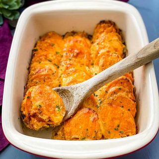 au gratin sweet potatoes in a red baking dish