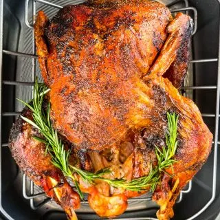 cajun roasted turkey in a roasting pan