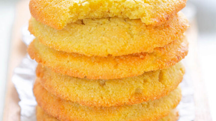 a stack of keto low carb lemon cookies, one on type with a bite taken out