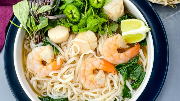 seafood shrimp pho in a white bowl