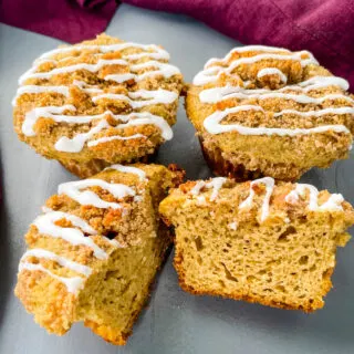 coffee cake muffins with icing on a flat surface