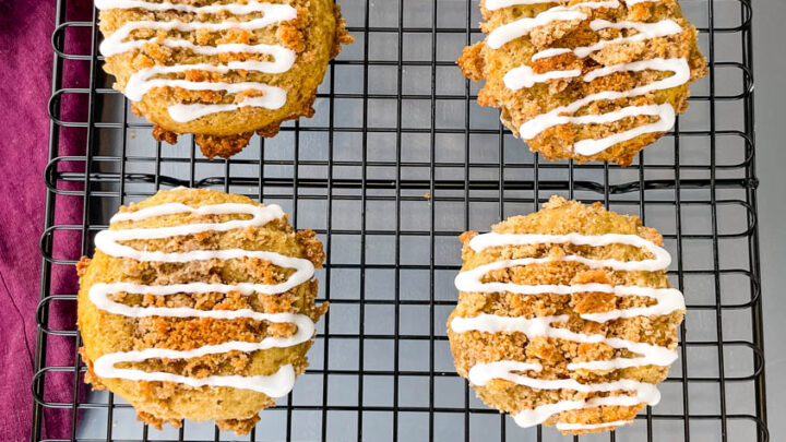 coffee cake muffins with icing on a cooling rack