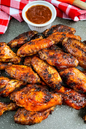 grilled chicken wings on a plate with BBQ sauce