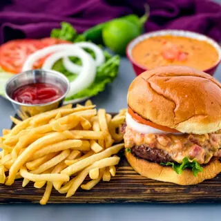 queso burgers on plate with French fries