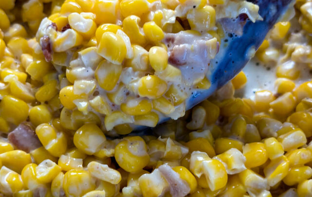 southern creamed corn in a spoon and skillet