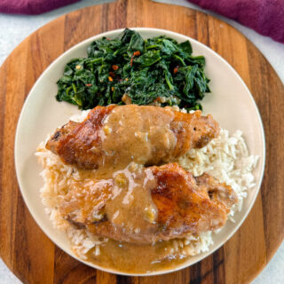 smothered turkey wings and gravy on a plate with white rice