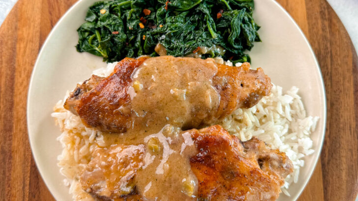 smothered turkey wings and gravy on a plate with white rice