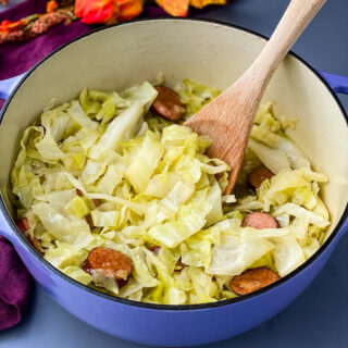 southern soul food cooked cabbage in a large pot with a wooden spoon