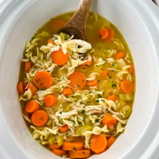 homestyle chicken noodle soup in a white pot