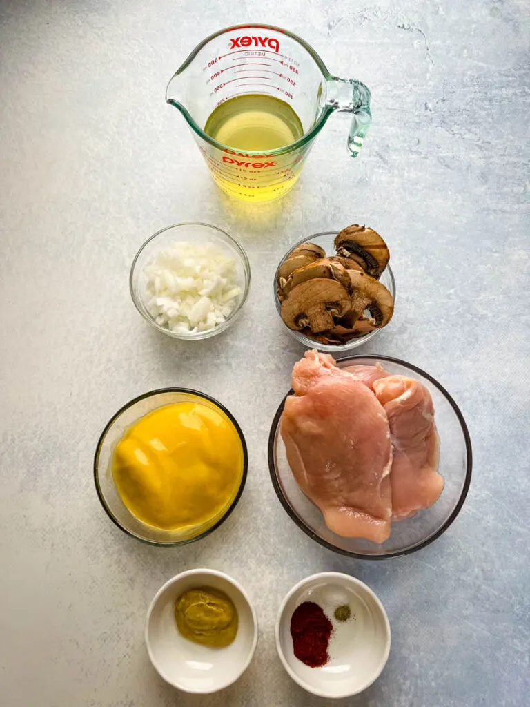 broth, onions, mushrooms, cream of chicken soup, chicken breasts, and spices in separate bowls