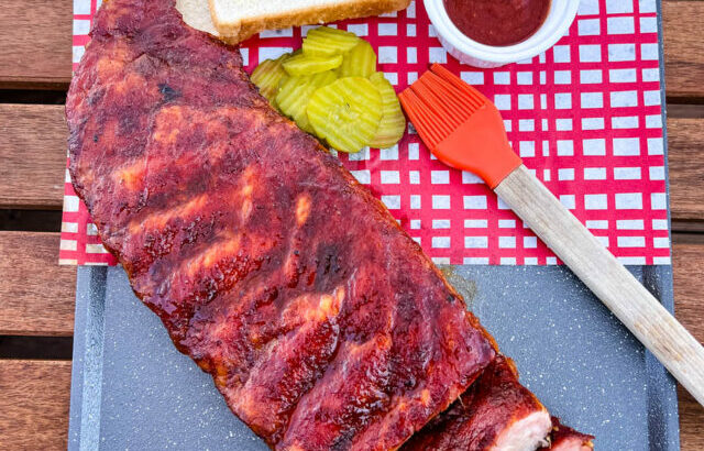 Traeger smoked ribs on a plate with pickles and white bread