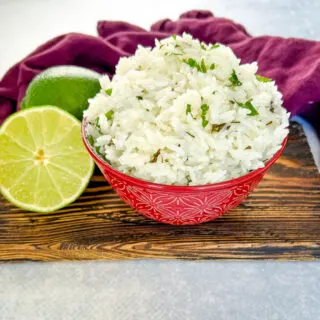 Chipotle cilantro lime rice in a bowl with fresh limes