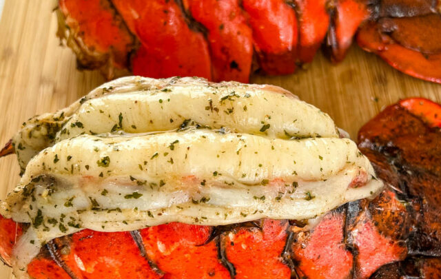 smoked lobster tails on a cutting board