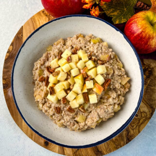 slow cooker crockpot apple oatmeal in a bowl with pecans