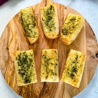 air fryer garlic bread on a wooden cutting board