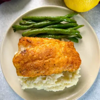 lemon pepper fish, mashed potatoes, and green beans on a plate