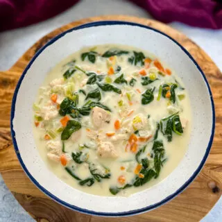 chicken florentine soup and spinach in a white bowl