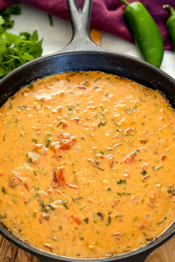 smoked queso cheese dip in a cast iron skillet