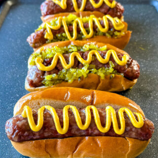 smoked brats on buns with mustard and relish