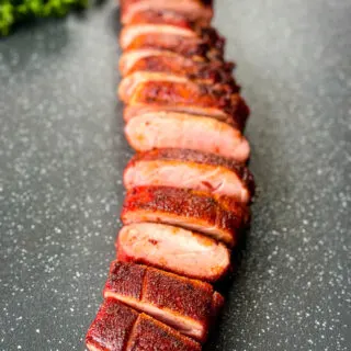 sliced smoked pork tenderloin on a flat surface