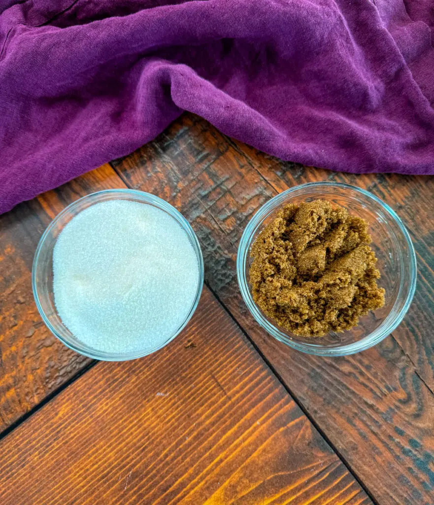 white sugar and brown sugar in separate glass bowls