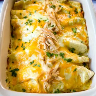 rotisserie chicken enchiladas in a red baking dish