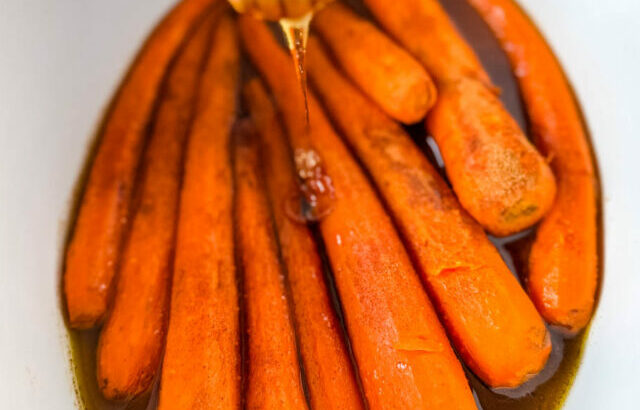 maple syrup drizzled over carrots in a Crockpot slow cooker