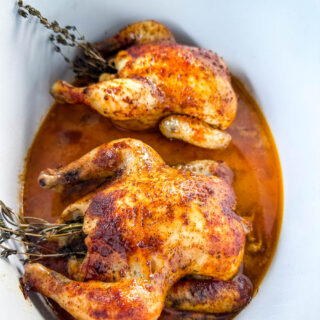 cornish hens in a Crockpot slow cooker with broth and herbs