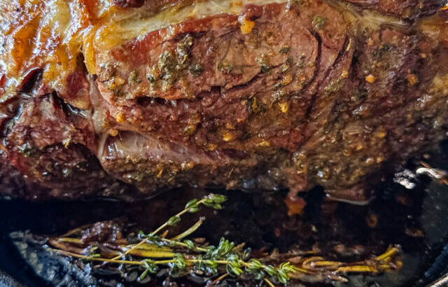 roasted garlic herb butter prime rib in a cast iron skillet