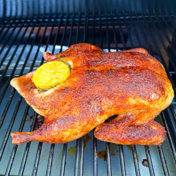 whole duck on a Traeger smoker pellet grill stuffed with lemon and herbs